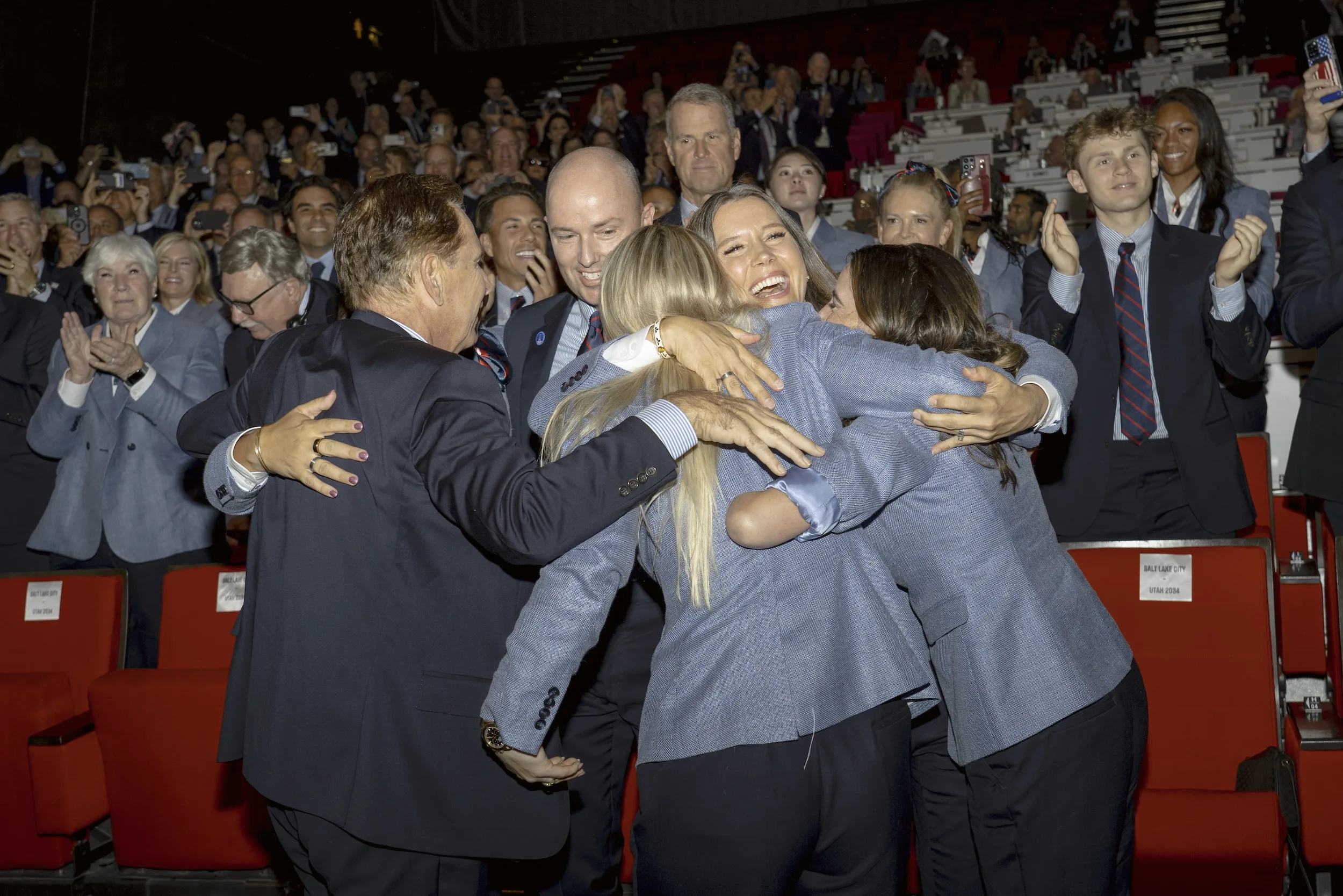 The delegation embraces as the winning bid is announced